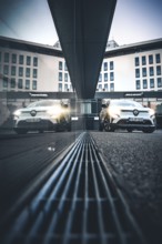 Car reflecting a modern building in an urban environment at dusk, Deer E-Carsharing, Renault
