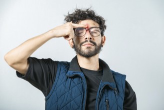 Person with nasal bridge ache isolated. Man with nasal bridge pain on white background
