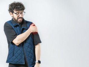 Young man with shoulder inflammation isolated. Person with pain and muscle tension in the shoulder