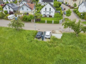 Aerial view of a residential area with street surrounded by green nature, Deer E-Carsharing, Calw,