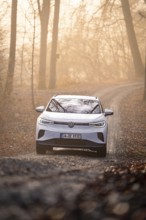 An SUV on a curvy forest path at dawn, Deer E-Carsharing, VW ID4, Calw, Germany