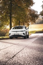 SUV on a barely traveled road, surrounded by autumn trees, deer e-car sharing, VW ID4, Calw,