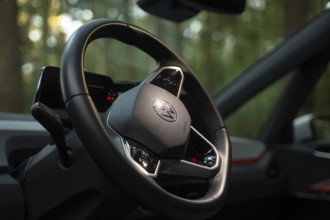 Close-up of a steering wheel in a car with a wooded background, Deer e-Carsharing, VW ID3, Calw,