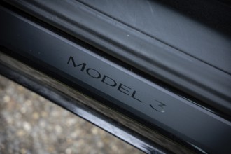 Close-up of Model 3 lettering on black metal, Deer E-Carsharing, Tesla Model 3, Calw, Germany