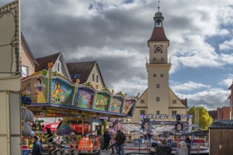 Children's carousel at the town festival on the market square, in the back the town hall, building