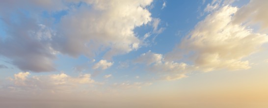 Colorful sunset sky showcases vibrant hues and fluffy clouds as day transitions into night,