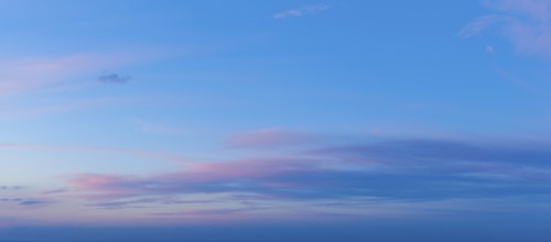 A beautiful twilight sky showcases vivid pink and blue colors as the sun sets, creating a serene