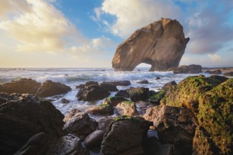 Penedo do Guincho stands majestically at Praia da Santa Cruz as ocean waves crash against the sandy
