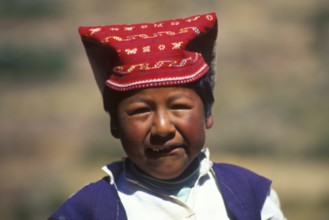 Little boy wearing traditional clothes on Isla Taquile in Lake Titicaca, Andean Highlands, Peru,