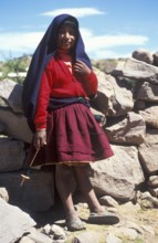 Little girl wearing traditional clothes on Isla Taquile in Lake Titicaca, Andean Highlands, Peru,