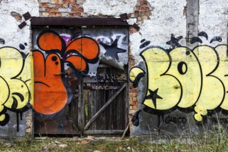 Alte Wand with Grafity and Gate of the dilapidated plant of a former agricultural production
