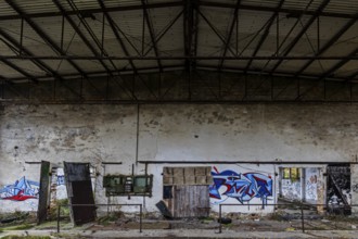 Old hall with Grafity, dilapidated plant of a former agricultural production cooperative of the