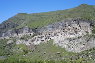A rocky cliff wall with numerous caves on a hill, cave town, cave monastery, Vardzia,
