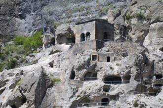 Monastery complex nestled in rocks. mixture of nature and historical architecture, cave city, cave