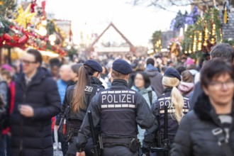 Three police officers are patrolling the Stuttgart 2025 Christmas market. Their presence ensures