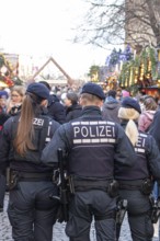 Three police officers are patrolling the Stuttgart 2025 Christmas market. Their presence ensures