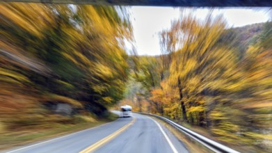 Motorhome, curvy country road, autumn leaves, Indian summer, traveling, symbolic photo, zoom