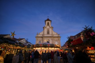 Carousel, catholic church of the Most Holy Trinity, people, visitors, baroque Christmas market,