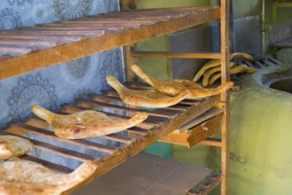 Fresh flatbread on rustic wooden shelves in a bakery, Samtskhe-Javakheti region,