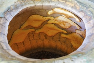 A traditional oven with several flatbreads in the baking process, Samtskhe-Javakheti region,