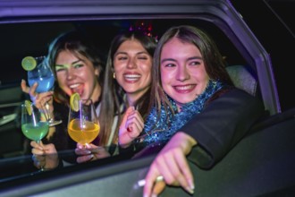 Young women friends smiling and having fun during a lively new year's eve party or celebration,