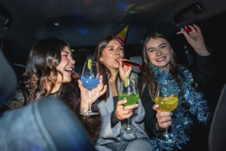 Three happy young women friends celebrating a cheerful new year's eve party in a vehicle, enjoying