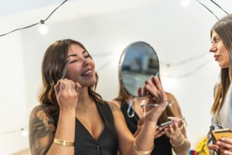 Young diverse women enjoying a fun time together, preparing for a special occasion party at home by