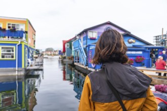 Tourist observing the colorful floating houses of fisherman's wharf park in victoria. British