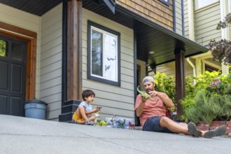 Father and son enjoying quality time together, bonding over dinosaur toys while sitting on their