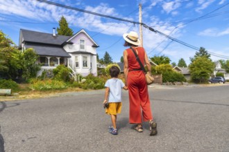 Tourist mother and son walking on a street in chemainus, vancouver island, british columbia,