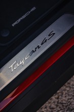 Close-up of a Porsche Taycan 4S emblem with focus on lettering and texture, Porsche Taycan, Deer