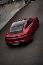 Red Porsche Taycan from a bird's eye view with focus on roof contours and rear, Porsche Taycan,