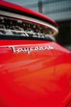 Close-up of Taycan lettering on a shiny red vehicle, Porsche Taycan, Deer Carsharing, Calw, Germany