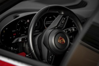 Close-up of Porsche steering wheel and dashboard in modern cockpit design, Porsche Taycan, Deer