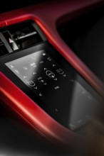 Close-up of car interior with red touchscreen control panel and modern displays, Porsche Taycan,