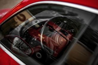 Reflected car interior with sporty design steering wheel, Porsche Taycan, Deer car sharing. Calw,