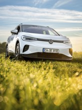 Silver car on green field at morning light, VW ID4 electric car, Deer Carsharing, Calw, Germany