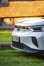 Close-up of a white car in front of a barn at sunset, VW ID4 electric car, Deer Carsharing, Calw,