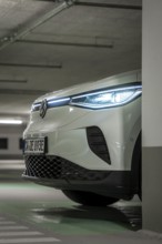 Modern car in an illuminated underground garage, sharp front view, VW ID4 electric car, deer car