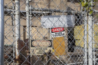 Washington, DC - Signs on a locked gate warn of high voltage and electrical hazards at a Pepco