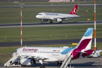 Turkish Airlines Airbus A320-200 landing at Düsseldorf airport, Eurowings Airbus on outdoor