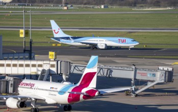 Eurowings aircraft, at Terminal A and TUI Fly Boeing 737 on the way to takeoff, Düsseldorf airport,