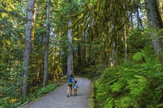 Mother and son enjoying a leisurely stroll along a tranquil gravel path, surrounded by the vibrant
