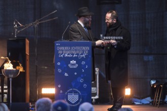 Igor Levit (pianist) receives a gift from Yehuda Teichtal (rabbi of the Chabad-Lubavitch movement)