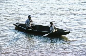 Father and child in a paddle boat on the Amazon near Iquitos, Peru, South America, September 1997,