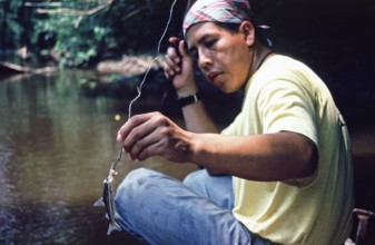 Man caught fish to be used as bait for piranhas, Rio Yanayacu, Amazon region near Iquitos, Peru,