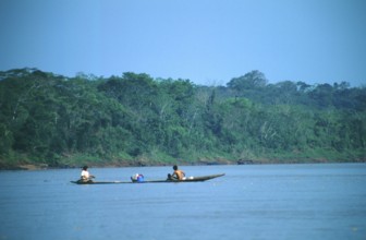 Boat traffic on the Rio Tambopata near Puerto Maldonado in the Amazon Basin, Peru, South America,