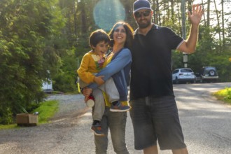 Happy family waving, enjoying their summer vacation in tofino, a popular tourist destination on