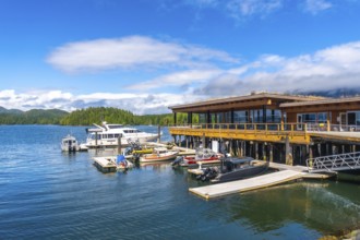 Modern architecture buildings overlooking clayoquot sound with boats moored at dock in tofino