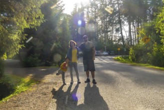 Happy family posing on a sunny day in tofino, vancouver island, british columbia, canada, enjoying